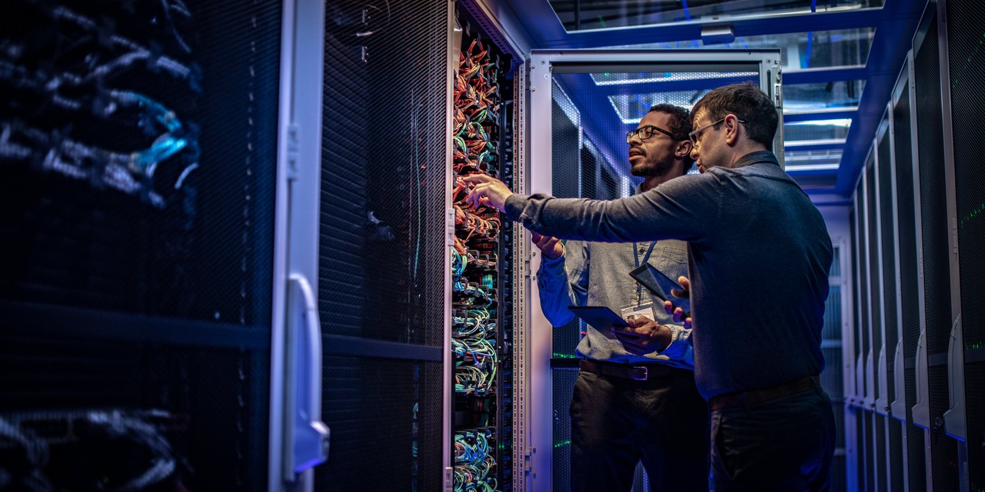 IT engineers checking servers in server room